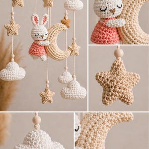 May include: A handmade crochet baby mobile featuring a wooden ring with hanging beige stars, white clouds, and a crescent moon. A white bunny wearing a pink dress is hugging the moon. The mobile is designed for a nursery.