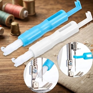 May include: Two plastic sewing machine needle threaders, one blue and one white, featuring a long handle and a hooked tip. Two circular insets show the threader in use, demonstrating how the hook passes through the eye of a sewing machine needle.