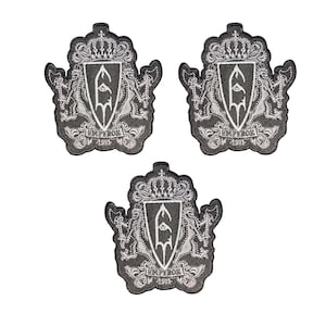 May include: Three identical black and white embroidered patches featuring a central shield with a stylised letter E, topped by a crown. The design includes flanking figures, the text EMPEROR, and the year 1991 at the base of each crest.