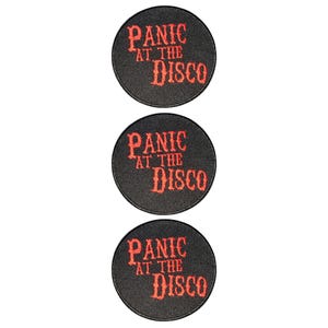 May include: Three circular black embroidered patches arranged vertically. Each patch features the text "PANIC AT THE DISCO" stitched in a bold, red, stylised font. The edges of each circular patch are finished with a black stitched border.