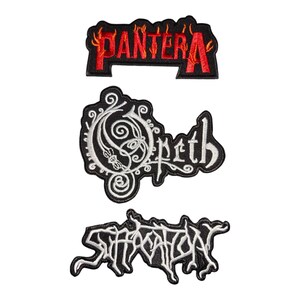 May include: Three embroidered fabric patches featuring band logos. The top patch displays the red and orange Pantera logo on a black background. The middle patch shows the white Opeth logo with ornate swirls. The bottom patch features the white Suffocation logo.