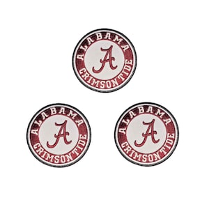 May include: Three circular embroidered patches featuring a white centre with a crimson red letter A. The border is a crimson red ring containing the white text ALABAMA CRIMSON TIDE, all enclosed within a thin black stitched outer edge.