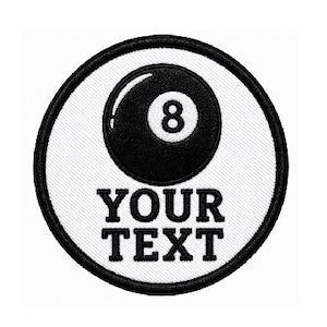 May include: A circular patch featuring a black and white design. The patch has a white background with a black border. The center shows a black eight ball with the number 8. Below the eight ball is the text "YOUR TEXT".