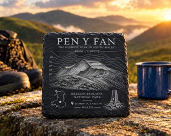 May include: A square black slate plaque featuring an engraved white illustration of Pen y Fan mountain, including topographic lines, the elevation of 886M and 2,907FT, a map of Wales, the Brecon Beacons National Park text, and coordinates.