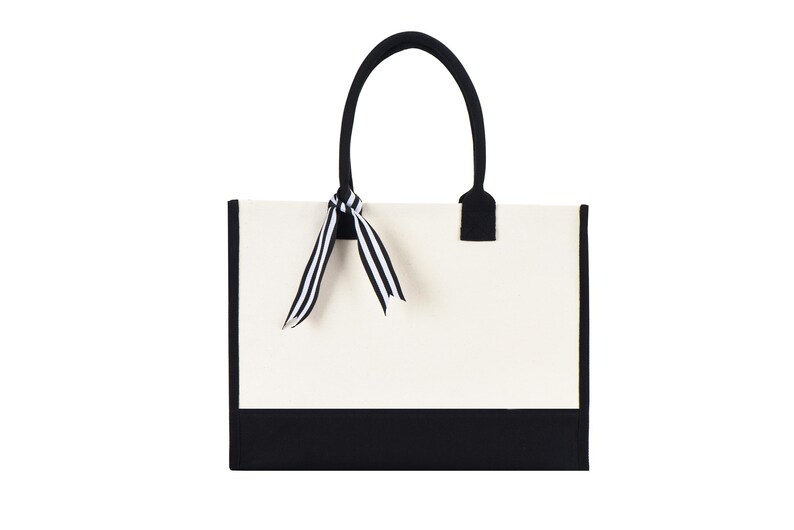 a black and white bag with a bow on it