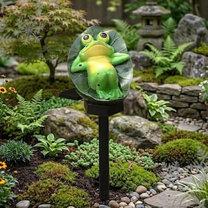 May include: A white ceramic mug with a black handle and the text "But First, Coffee" in a black, bold font. The mug is on a white surface.