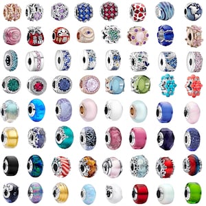 May include: A collection of sixty-four assorted metal and glass charms for bracelets, featuring various shapes, colors, and textures including floral, geometric, and spherical designs, some with embedded crystals and engraved details.