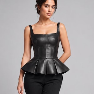 May include: A black sleeveless leather peplum top with a square neckline and structured bodice, paired with slim-fit black trousers and black high-heeled pumps. The top features a flared waist detail and vertical seam lines throughout the bodice.