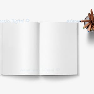 May include: An open blank book with a white background. A silver pencil holder with a variety of colored pencils is on the right side of the image.