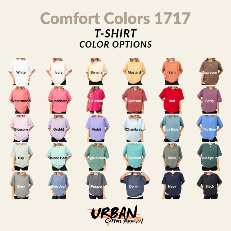 Op de afbeelding: Een display van Comfort Colors 1717 t-shirts in verschillende kleuren, waaronder wit, ivoor, banaan en mosterd. Andere kleuren zijn watermeloen, grunchberry en karmozijnrood. Het Urban Cotton Apparel-logo staat onderaan.