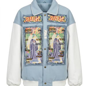 May include: A light blue varsity jacket with white sleeves and a ribbed collar. The front features two large rectangular patches with frayed edges, displaying a colorful illustration of a figure and the text "RICH" and "RICH GAINER".