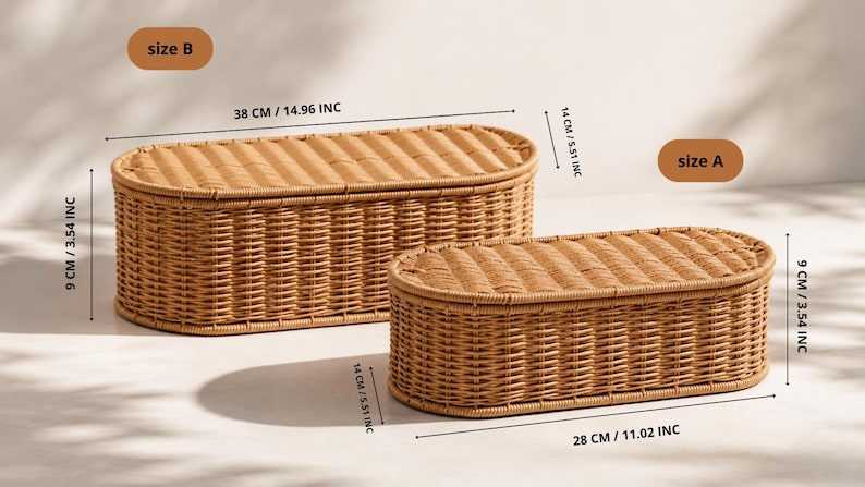 May include: Two woven wicker storage baskets, one large and one small, with oval shapes and lids. The larger basket is 38 cm (14.96 inches) long, 14 cm (5.51 inches) wide, and 9 cm (3.54 inches) high. The smaller basket is 28 cm (11.02 inches) long.