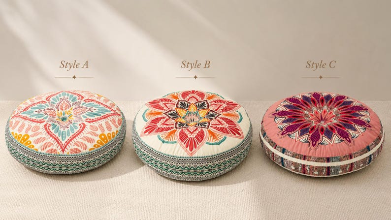 May include: Three round floor cushions labeled Style A, Style B, and Style C. Style A features a teal, pink, and yellow floral pattern. Style B has a red, orange, and yellow mandala design on cream. Style C displays a purple and pink floral motif.