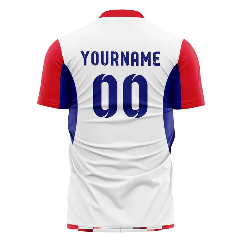 May include: White athletic jersey with red and blue accents. The back features the name "YOURNAME" in navy blue above the number "00". The sleeves are red, and the sides have blue panels.