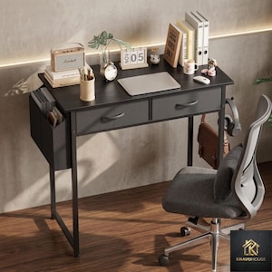 May include: A dark gray desk with two drawers, a side storage compartment, and a metal frame. The desk is accessorized with a laptop, books, a speaker, and a desk chair. The desk is designed for a home office or workspace.