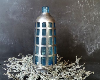 Blue glass bottle with chrome cage
