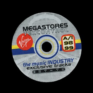 May include: A circular embroidered patch featuring a silver-grey background with black text reading MEGASTORES TEXCONTROL, the music INDUSTRY exclusive tracks, and VXT-TV. It includes a red circular logo, a blue and yellow stripe, and a red square.