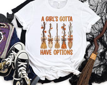 A Girl's Gotta Have Options Shirt Witch Broomsticks Halloween Spooky Season Apparel