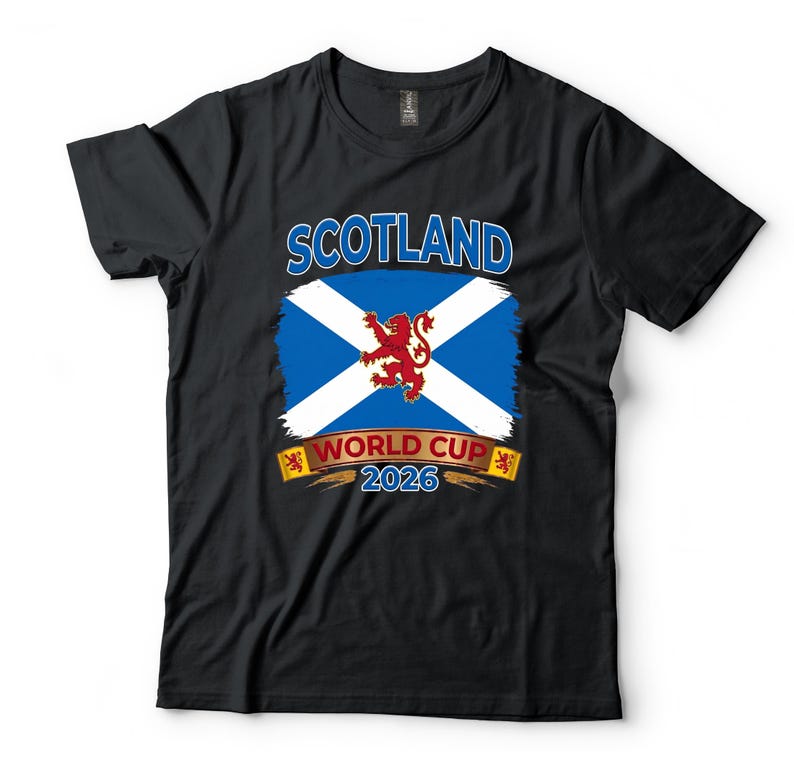 May include: Black t-shirt featuring the Scottish flag with a white cross on a blue background, a red lion, and the text "SCOTLAND WORLD CUP 2026". The design is printed on the front of the shirt.