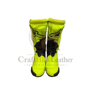 May include: Pair of neon yellow and black motorcycle boots. The boots have a tall design, with black accents on the front and sides. The boots have the brand logo on the side.