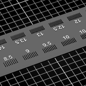 May include: A white ceramic mug with a black handle and the text "But First, Coffee" in a black, bold font. The mug is on a white surface. The mug is approximately 4 inches tall.