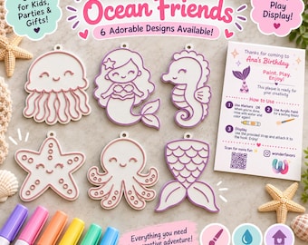 May include: A Paint-Your-Own Ocean Friends set featuring six white plastic shapes with purple outlines: a jellyfish, mermaid, seahorse, starfish, octopus, and mermaid tail. Includes five colored markers and an instructional card for Ana's Birthday.
