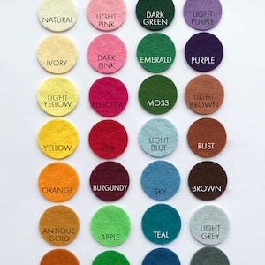 May include: Wool felt color chart with 24 different colors, including white, peach, mint, midnight, natural, light pink, dark green, light purple, ivory, dark pink, emerald, purple, light yellow, fuchsia, moss, light brown, yellow, red, light blue, rust, orange, burgundy, sky, brown, antique gold, apple, teal, light grey, ginger, lime, cobalt, dark grey, olive, green, royal, and black.