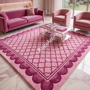 May include: A large rectangular area rug featuring a light pink center with a darker pink lattice pattern. The border consists of a scalloped edge in a deep magenta hue. The text RugsArt is printed in white across the center of the rug surface.