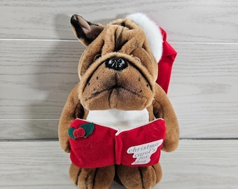 Peluche navideño vintage de JCPenney de los años 90, perro que ladra y villancica, 28 cm (11 pulgadas), incluye gorro de Papá Noel y libro.