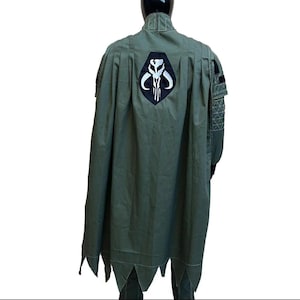Back view of a hunter green Mandalorian inspired flight suit costume for men featuring a custom cape and detailed bounty hunter design. This Star Wars cosplay outfit showcases the rear construction, cape drape, and flight suit tailoring, making it ideal for Din Djarin inspired cosplay, Comic Con events, Halloween costumes, cosplay conventions, fan gatherings, and sci fi costume collections. Custom sizing available for a comfortable and authentic cosplay fit.