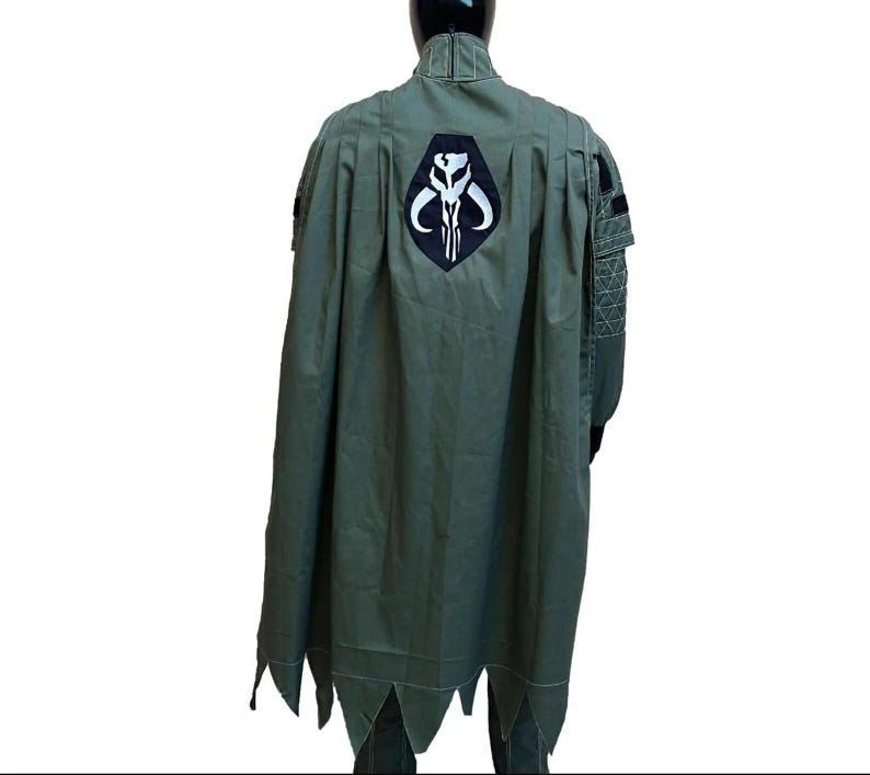 Back view of a hunter green Mandalorian inspired flight suit costume for men featuring a custom cape and detailed bounty hunter design. This Star Wars cosplay outfit showcases the rear construction, cape drape, and flight suit tailoring, making it ideal for Din Djarin inspired cosplay, Comic Con events, Halloween costumes, cosplay conventions, fan gatherings, and sci fi costume collections. Custom sizing available for a comfortable and authentic cosplay fit.