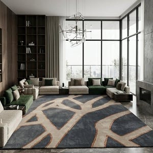May include: A modern living room featuring a large area rug with a blue and beige abstract design. The room includes multiple beige and green sectionals, a dark wood bookshelf, and a large window with a view.