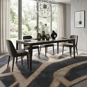 May include: A modern dining room set with a dark wood table, four gray upholstered chairs, and a patterned rug. The table is set with plates and vases. A large, spherical chandelier hangs above the table. The rug has a geometric design in shades of gray and beige.