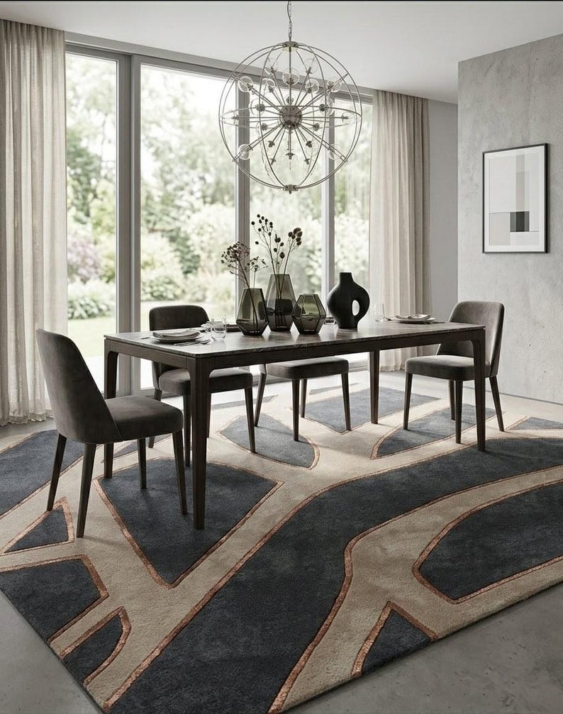May include: A modern dining room set with a dark wood table, four gray upholstered chairs, and a patterned rug. The table is set with plates and vases. A large, spherical chandelier hangs above the table. The rug has a geometric design in shades of gray and beige.