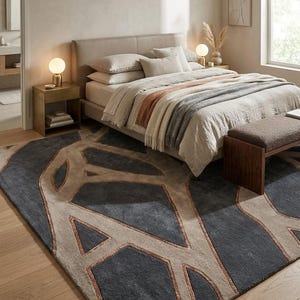 May include: A bedroom scene featuring a bed with neutral-toned bedding, a patterned rug, and a wooden bench. The rug has a geometric design in shades of gray, beige, and copper. Two small lamps sit on the nightstands.