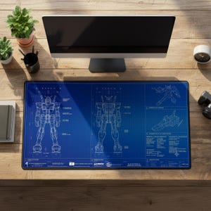 May include: A rectangular desk mat featuring a blue technical blueprint design of a Gundam robot. The print includes front and rear elevation views, perspective sketches, and technical specifications with text labels like "Gundam RX-78-2" and "Earth Federation Forces" in white.