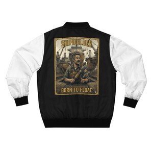 May include: Black and white bomber jacket with a graphic on the back. The graphic features a shipbuilder holding tools, with the words "SHIPBUILDER" and "BORN TO FLOAT". The jacket has white sleeves and black trim.