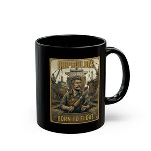 May include: Black ceramic mug featuring a vintage-style illustration of a shipbuilder. The design includes a man with a mustache holding tools, with the words "SHIPBUILDER" and "BORN TO FLOAT" in a gold-colored frame. The mug has a curved handle.