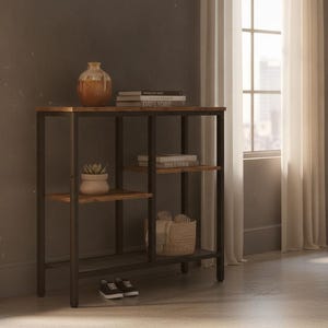 May include: A rectangular console table with a dark metal frame and three wooden shelves. The top shelf holds a round vase and a stack of books. The middle shelf features a small potted plant and another stack of books. A woven basket sits on the bottom shelf.