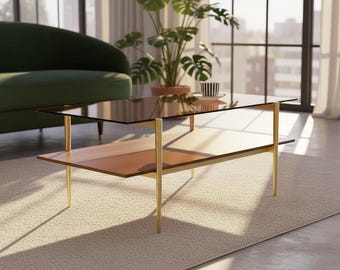 A Mid-Century Modern Rectangle Coffee Table with Amber Glass Top, Walnut 2-Tier Shelf, and Gold Conical Legs for Stylish Living Rooms