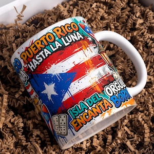 May include: White ceramic mug featuring the Puerto Rican flag design with the text "GO PUERTO RICO HASTA LA LUNA" and "ISLA DEL ENCANTO ORGULLO BORICUA". The mug has a white handle and is set in a box with brown paper.