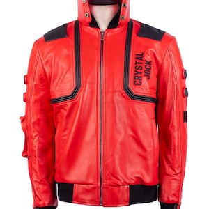 May include: A red leather jacket with black accents and the text "CRYSTAL JOCK" on the chest. The jacket features a high collar, a zipper closure, and black ribbed cuffs and hem. The jacket has black shoulder pads and decorative buttons.