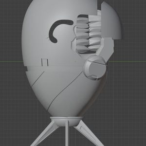 Op de afbeelding: Een lichtgrijs 3D digitaal model van een eivormig object met een statiefbasis. Het object heeft een gebogen zijopening die een rij tanden onthult, een glad buitenoppervlak met paneellijnen en een getextureerd cirkelvormig bovengedeelte.