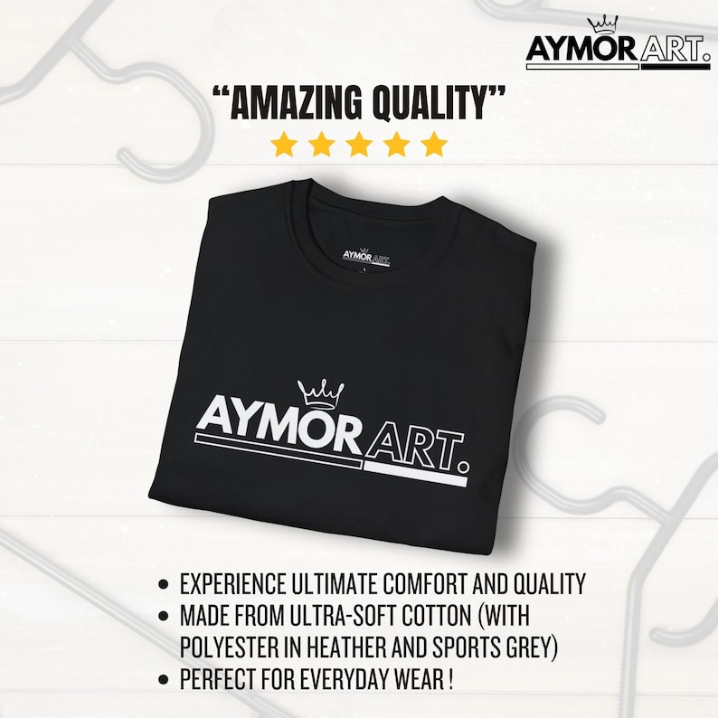 May include: A black t-shirt featuring a white graphic logo that reads AYMOR ART with a crown icon above the text. The shirt is displayed with text above that reads AMAZING QUALITY with five yellow stars and bullet points below the shirt.