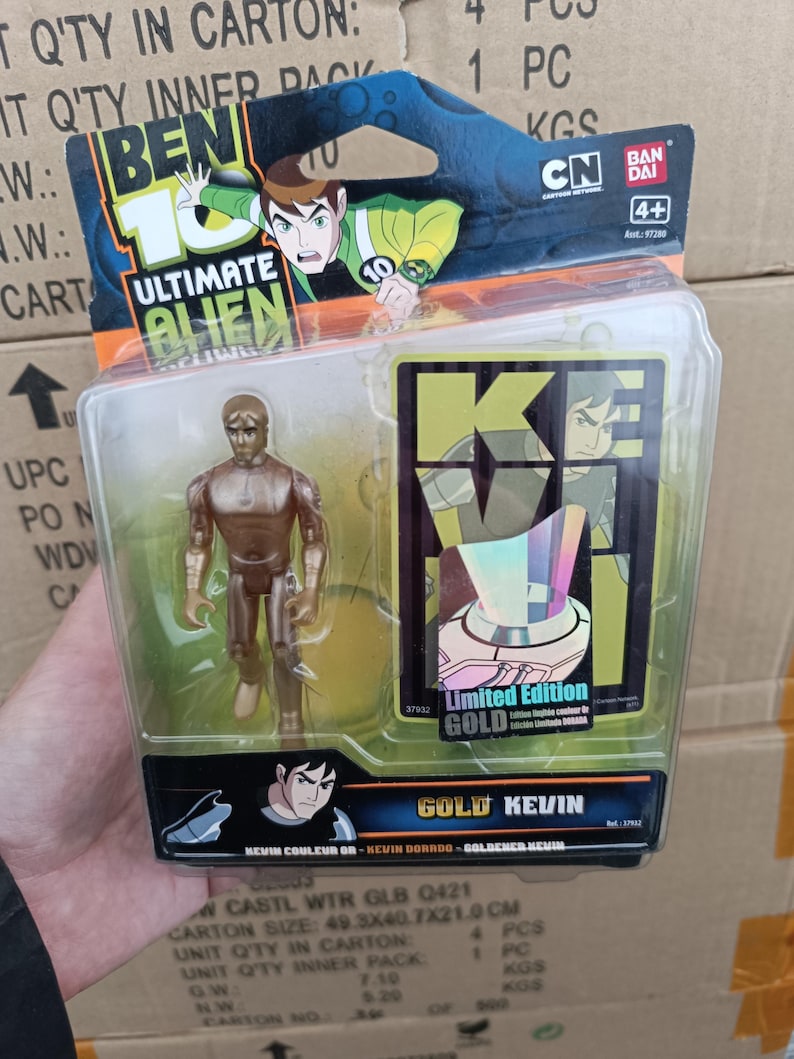 May include: A packaged "Ben 10 Ultimate Alien" action figure, featuring a gold-colored Kevin figure. The packaging includes the "Ben 10" logo, "Ultimate Alien" text, and "Limited Edition GOLD" text. The carton size is 49.3x40.7x21.9 cm.