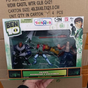 May include: A Ben 10 action figure set featuring Vilgax, Aggregor, and Vulkanus. The figures are in a clear plastic package with a green and black border. The package has the Toys R Us and Cartoon Network logos.