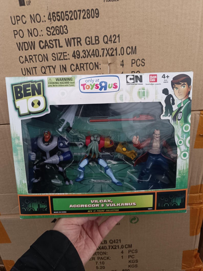 May include: A Ben 10 action figure set featuring Vilgax, Aggregor, and Vulkanus. The figures are in a clear plastic package with a green and black border. The package has the Toys R Us and Cartoon Network logos.