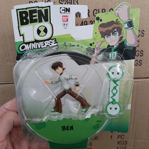 May include: A Ben 10 Omniverse action figure in a clear plastic package. The figure is of a cartoon character in a white and green outfit. The packaging includes the text "BEN 10" and "OMNIVERSE".