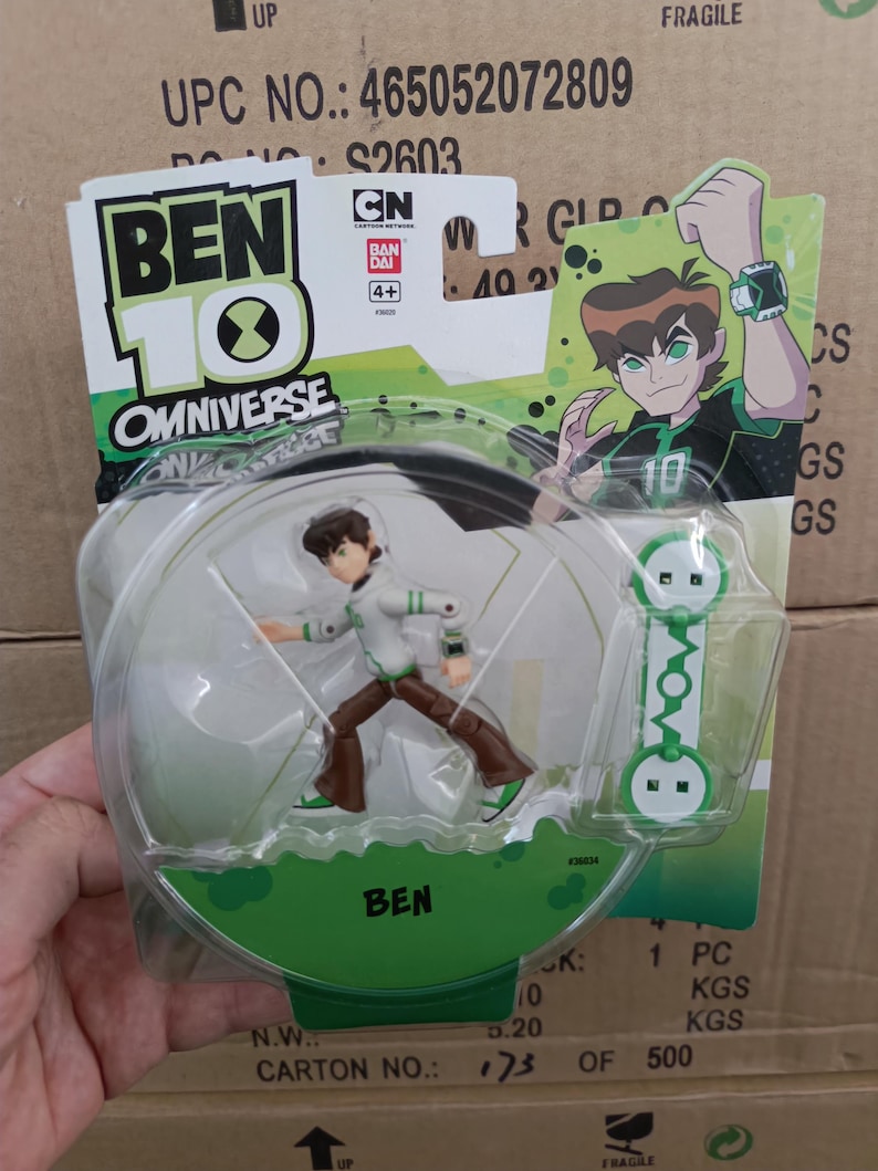 May include: A Ben 10 Omniverse action figure in a clear plastic package. The figure is of a cartoon character in a white and green outfit. The packaging includes the text "BEN 10" and "OMNIVERSE".