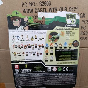 May include: The back of a Ben 10 Omnitrix Challenge V.2 toy package. The package features cartoon illustrations of characters and the Ben 10 logo. The package includes the text "Collect Them All" and "Battle to Win".